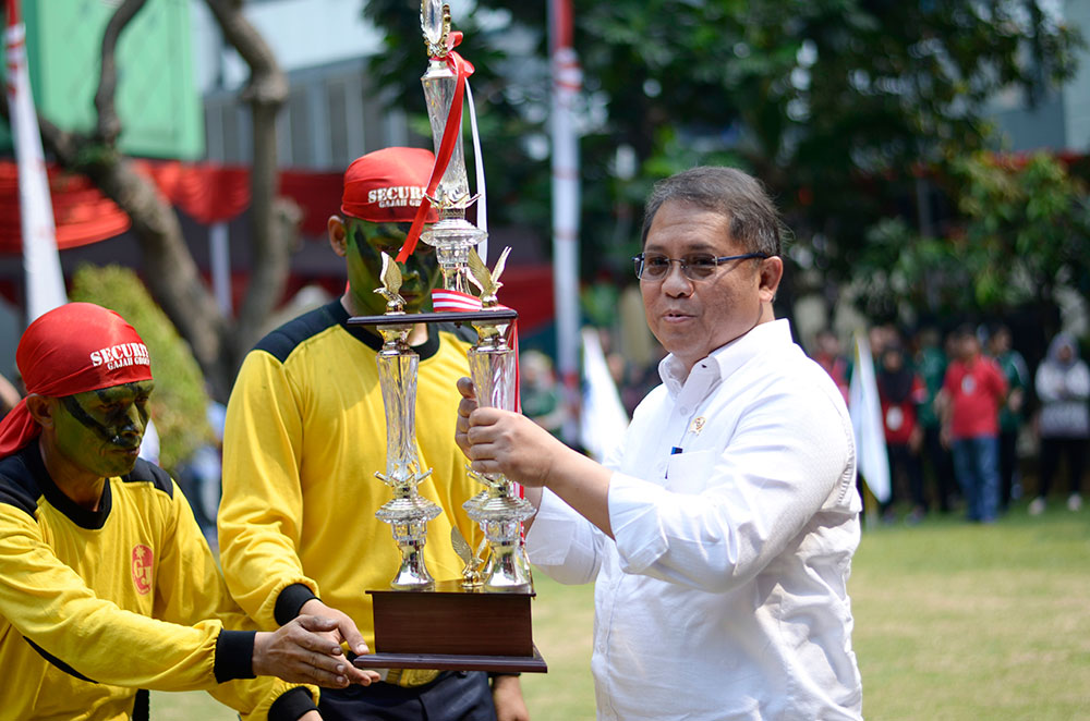 Menkominfo Rudiantara menyerahkan piala kepada juara Porseni 2018 Kominfo yang digelar untuk merayakan HUT RI ke-73, di Lapangan Anantakupa, Gedung Kemkominfo, Jakarta, Rabu (15/8/2018)